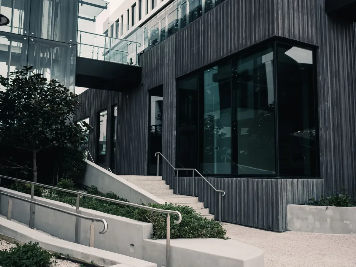 Concrete steps with metal handrails leading up to a modern office building