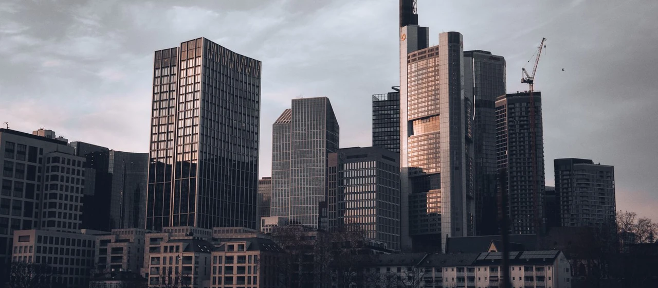 Financial-district skyline at dusk, evoking European private-equity fund management and the Luxembourg carried interest regime