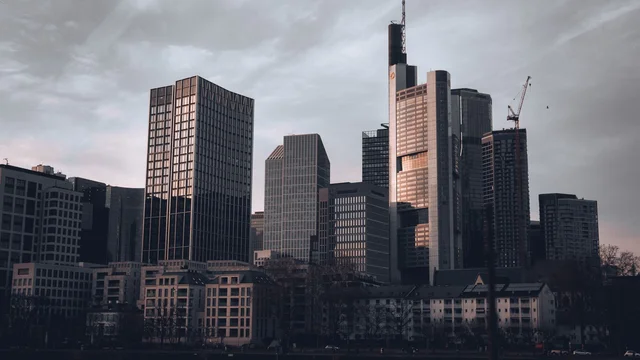 Financial-district skyline at dusk, evoking European private-equity fund management and the Luxembourg carried interest regime